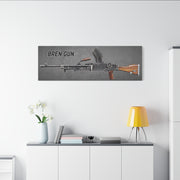 Canvas print of a Bren Gun on a wall above a white cabinet with decor items.