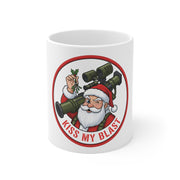 White mug with a graphic of Santa Claus holding a mortar and text 'Kiss My Blast' on a white background