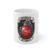 White mug with a graphic of a red grenade with Santa Claus face, 'Decorate' and 'Detonate' text on a white background.