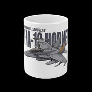 A white ceramic mug featuring a printed graphic of a McDonnell Douglas F/A-18 Hornet fighter jet in gray with a small orange accent, alongside the text 'McDonnell Douglas' and 'F/A-18 HORNET'.