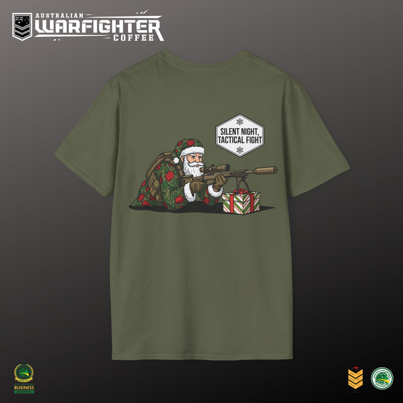 Green t-shirt with a graphic of Santa Claus holding a rifle and presents, on a dark background.