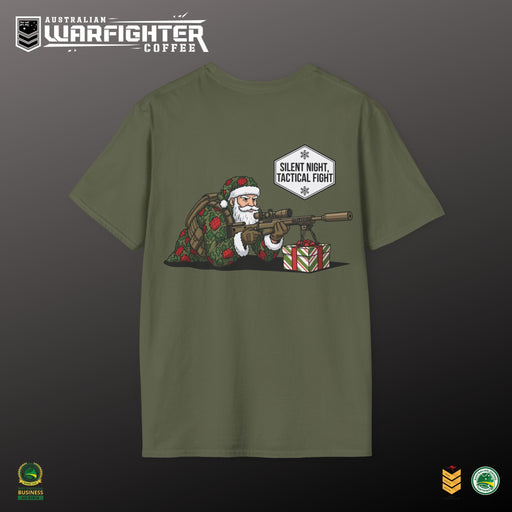 Green t-shirt with a graphic of Santa Claus holding a rifle and presents, on a dark background.