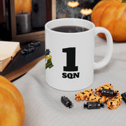 White mug with '1 Sqn' design, surrounded by Halloween-themed treats on a table.