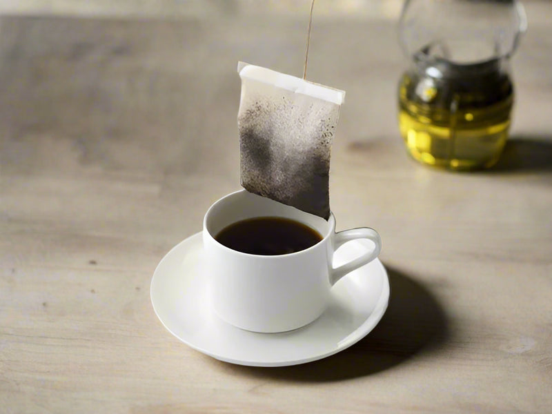 Australian Warfighters Coffee TIER 1 Tactical Roast steeped filter bag in cup – veteran-owned single-serve coffee